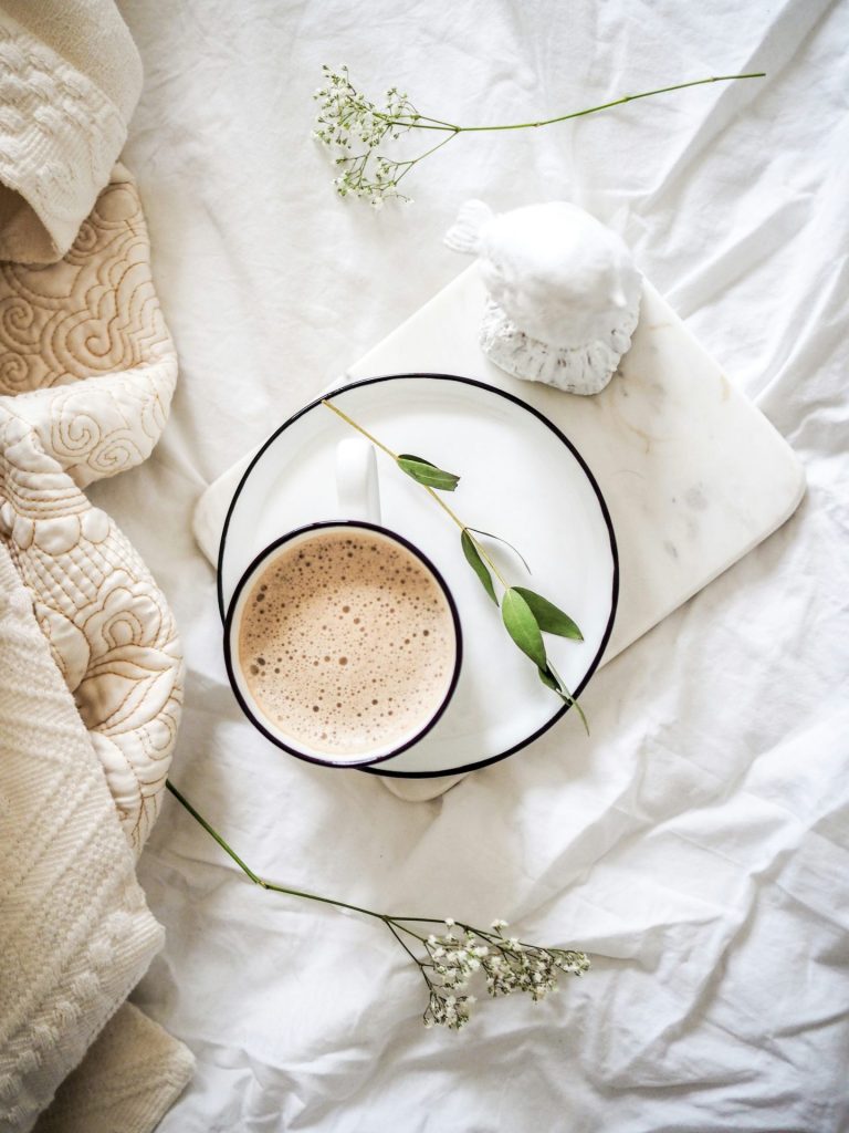 Morning Coffee On a White Bed Sheet