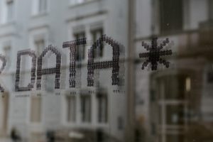 The word Data on a window with a reflection of a white building